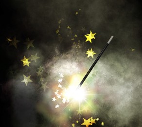 Image of Magic wand and enchanted stars on dark background
