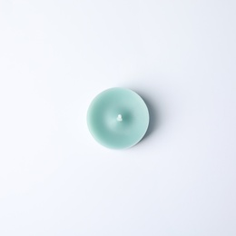 Photo of Light blue wax decorative candle isolated on white, top view