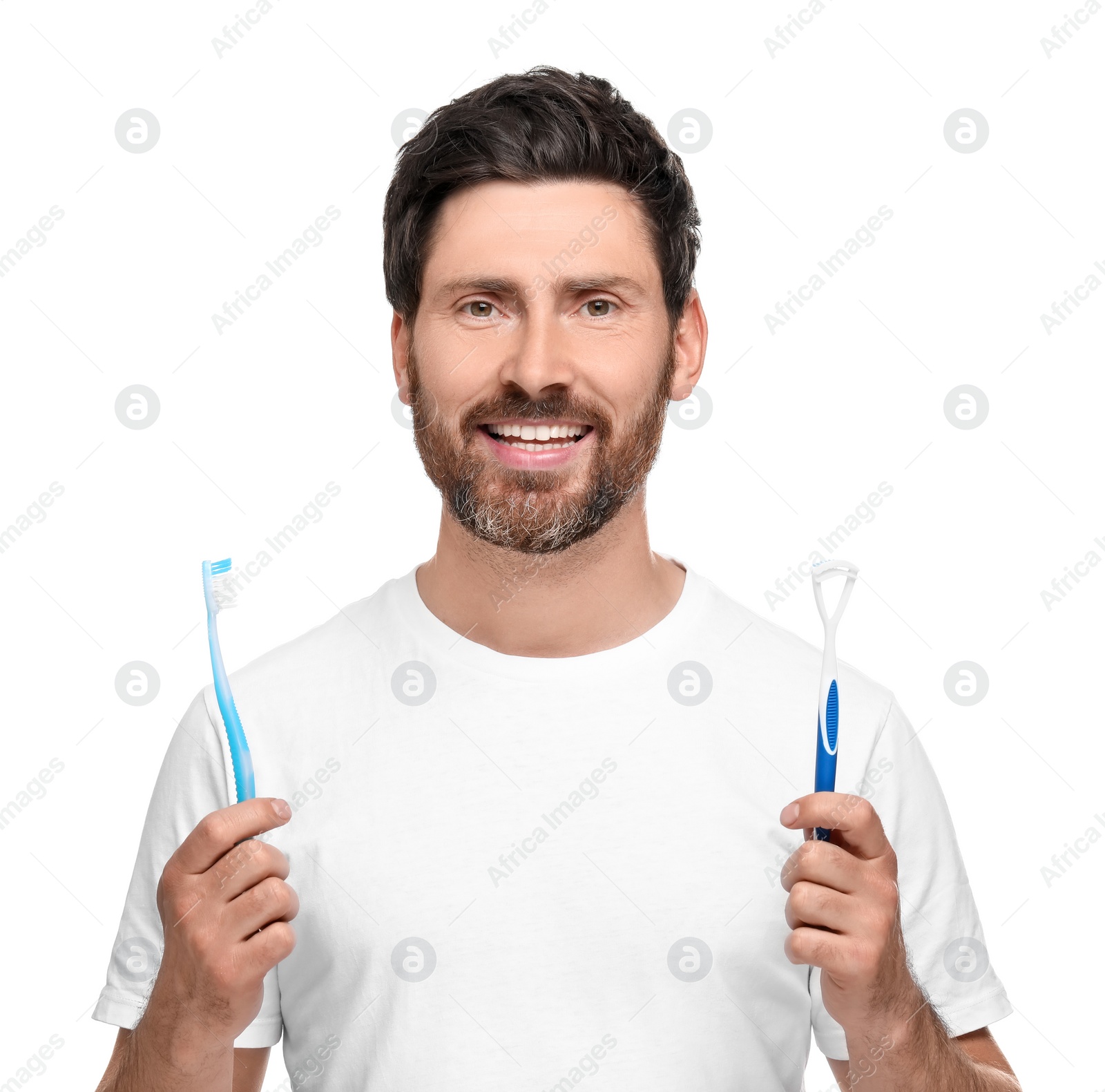 Photo of Happy man with tongue cleaner and plastic toothbrush on white background