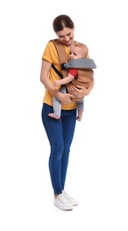 Woman with her son in baby carrier on white background