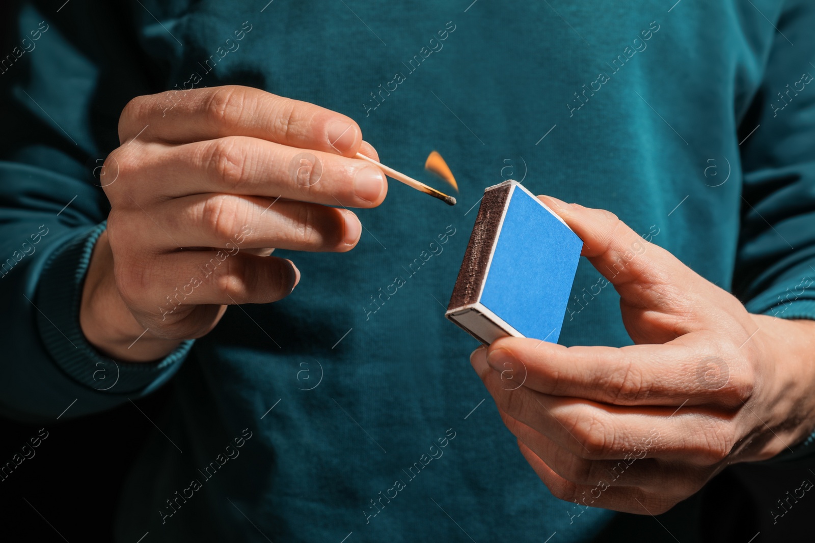 Photo of Man with box of matches, closeup of hands