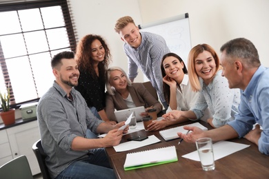 Portrait of volunteers having meeting in office