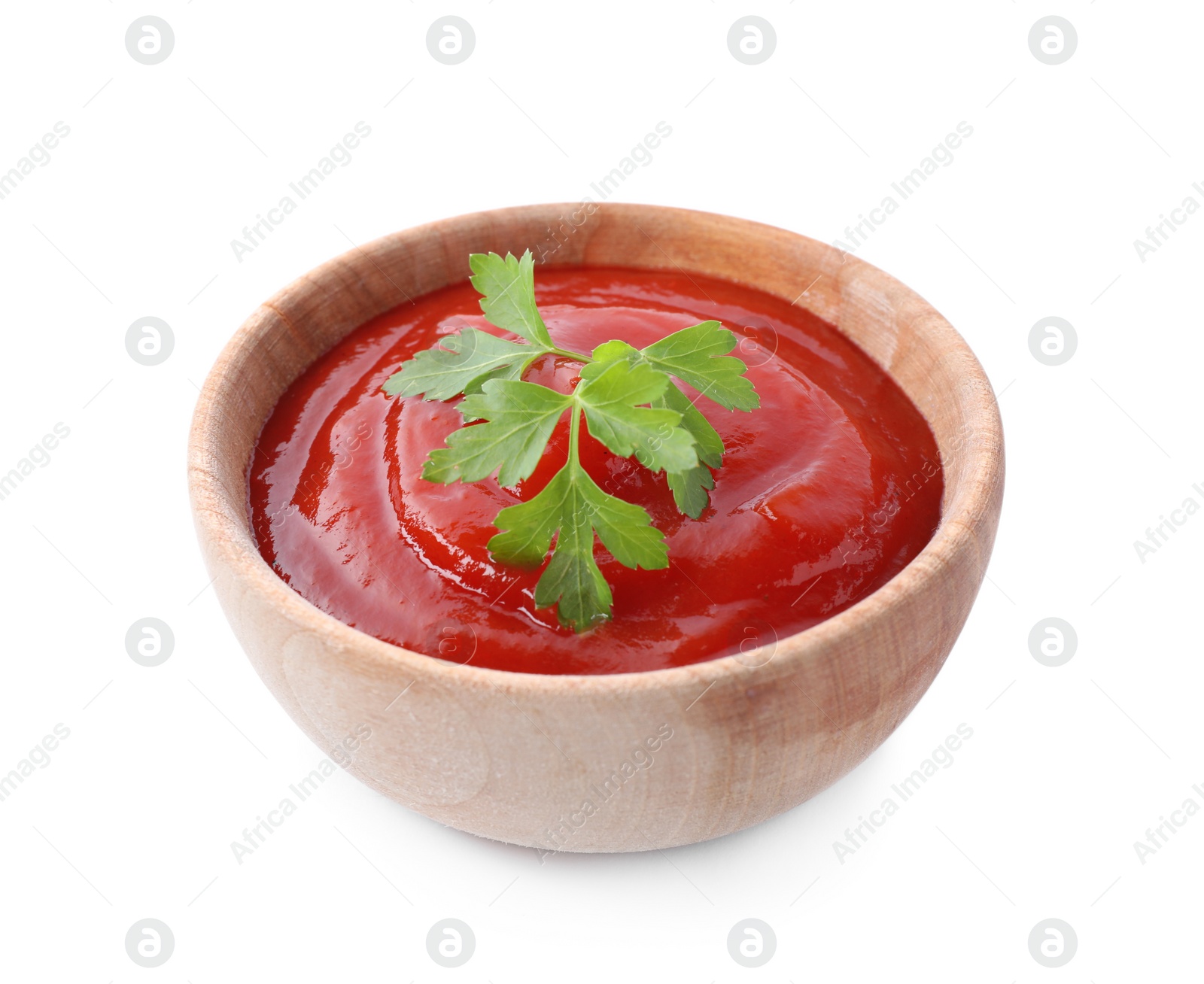 Photo of Tasty tomato sauce with parsley in wooden bowl isolated on white