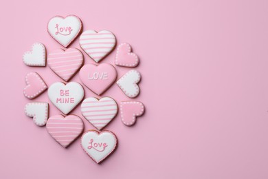 Photo of Delicious heart shaped cookies on pink background, flat lay. Space for text