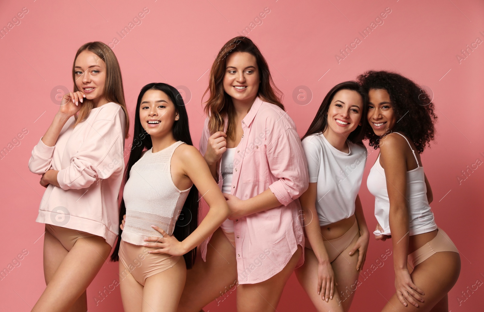 Photo of Group of women with different body types in underwear on pink background