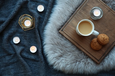 Photo of Flat lay composition with burning candles on fabric