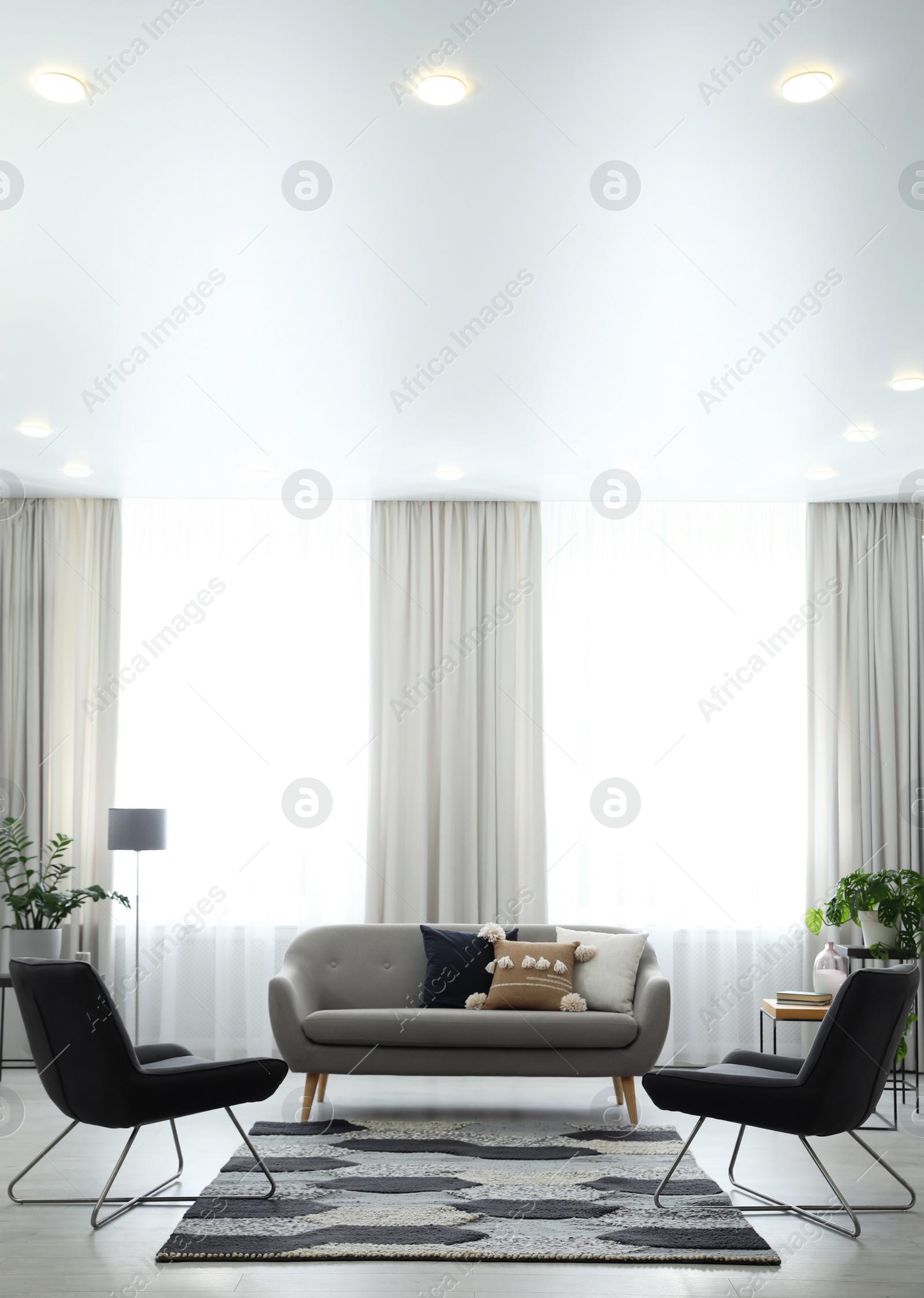 Photo of Modern living room interior with comfortable sofa and armchairs