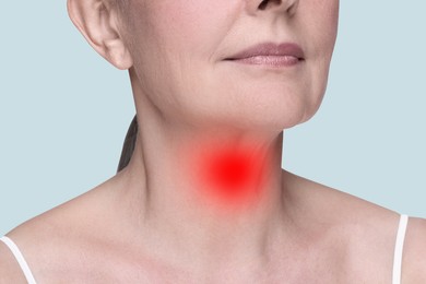 Endocrine system. Woman suffering from pain in thyroid gland on light grey background, closeup