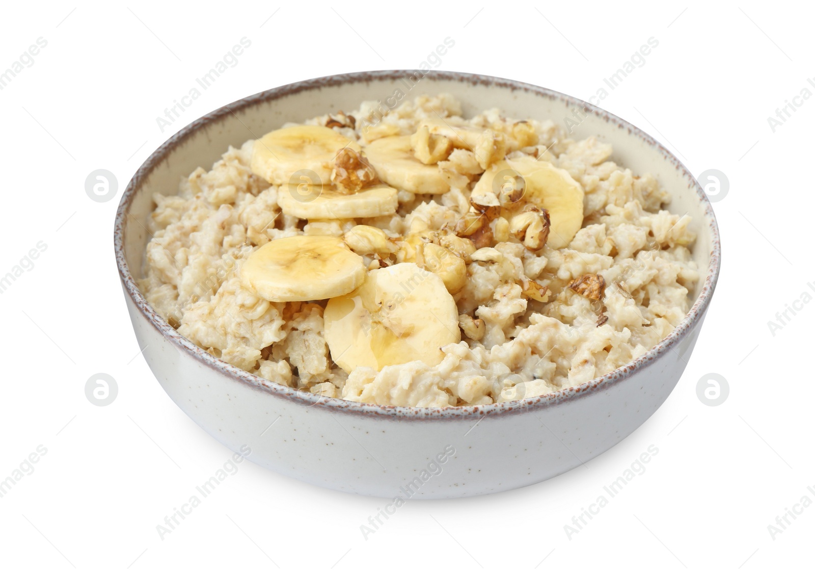 Photo of Tasty oatmeal with banana and walnuts in bowl isolated on white