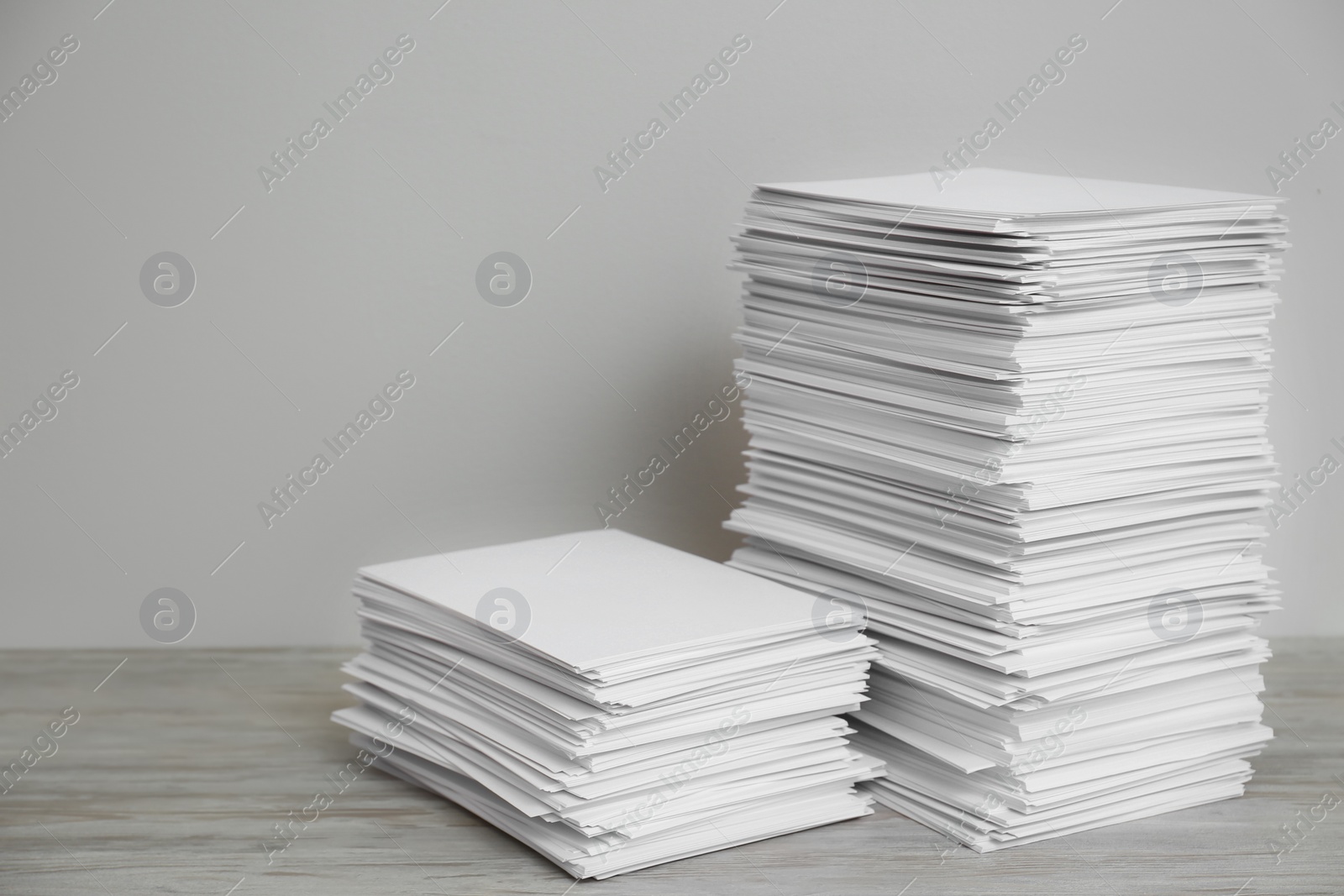 Photo of Stacks of paper sheets on wooden table