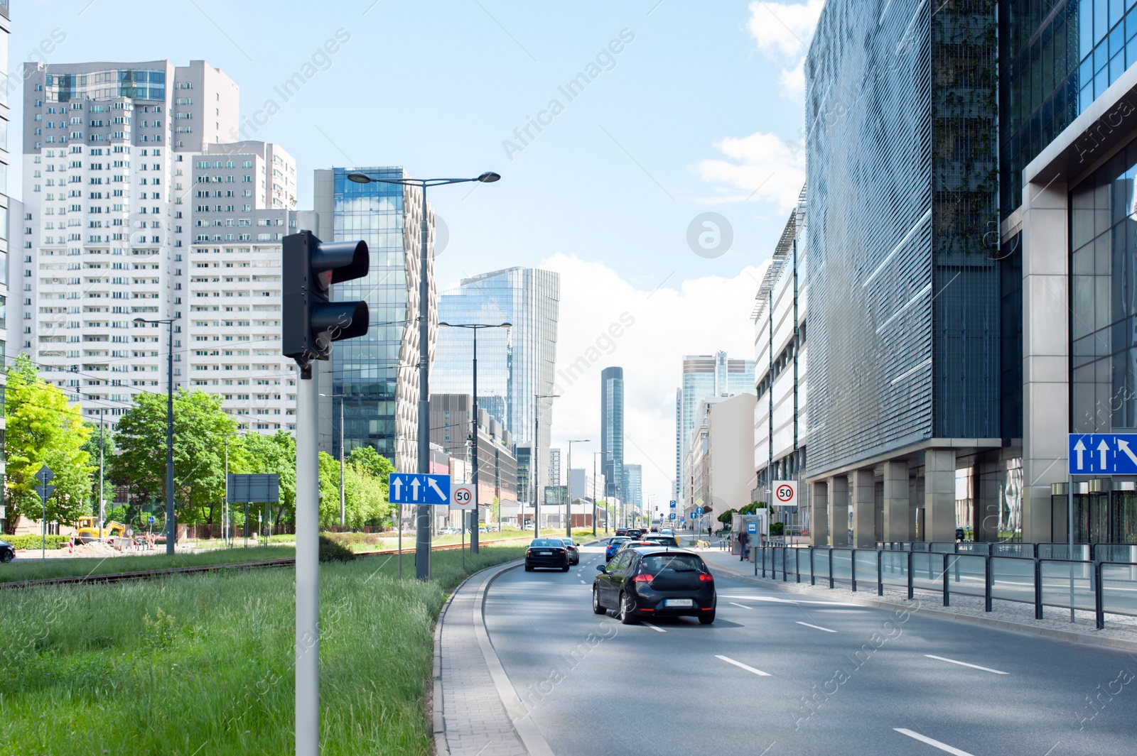 Photo of Road, lawn, cars and beautiful buildings in city