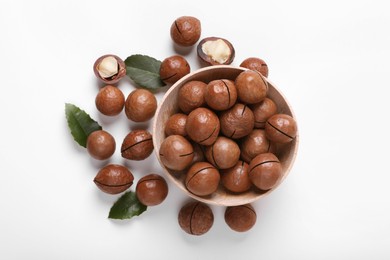 Photo of Delicious organic Macadamia nuts on white background, flat lay