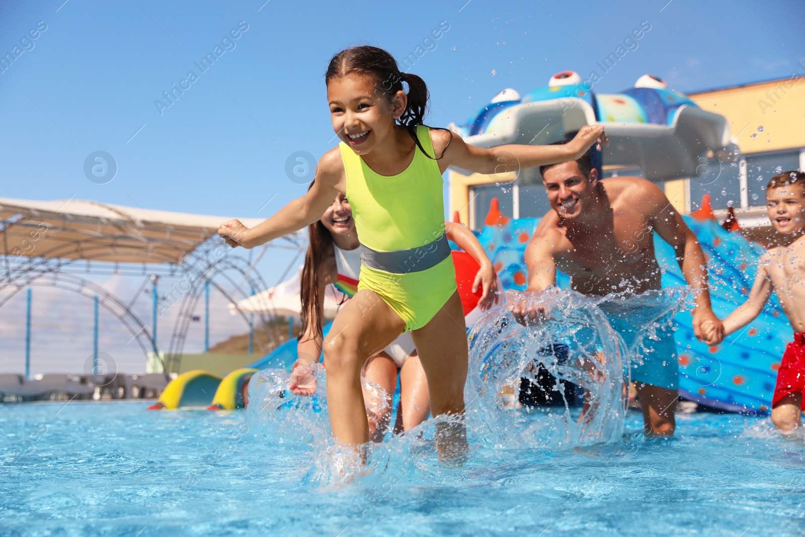 Photo of Happy family having fun at water park. Summer vacation