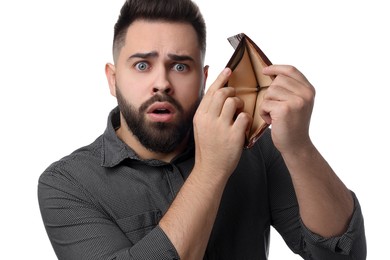 Confused man showing empty wallet on white background