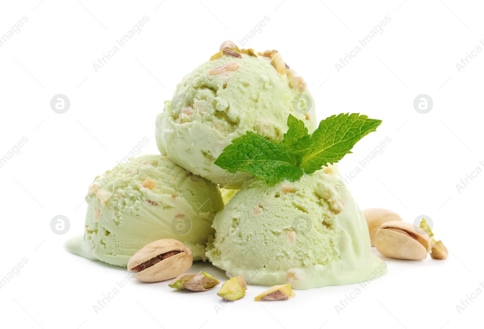 Photo of Scoops of delicious pistachio ice cream with mint and nuts on white background