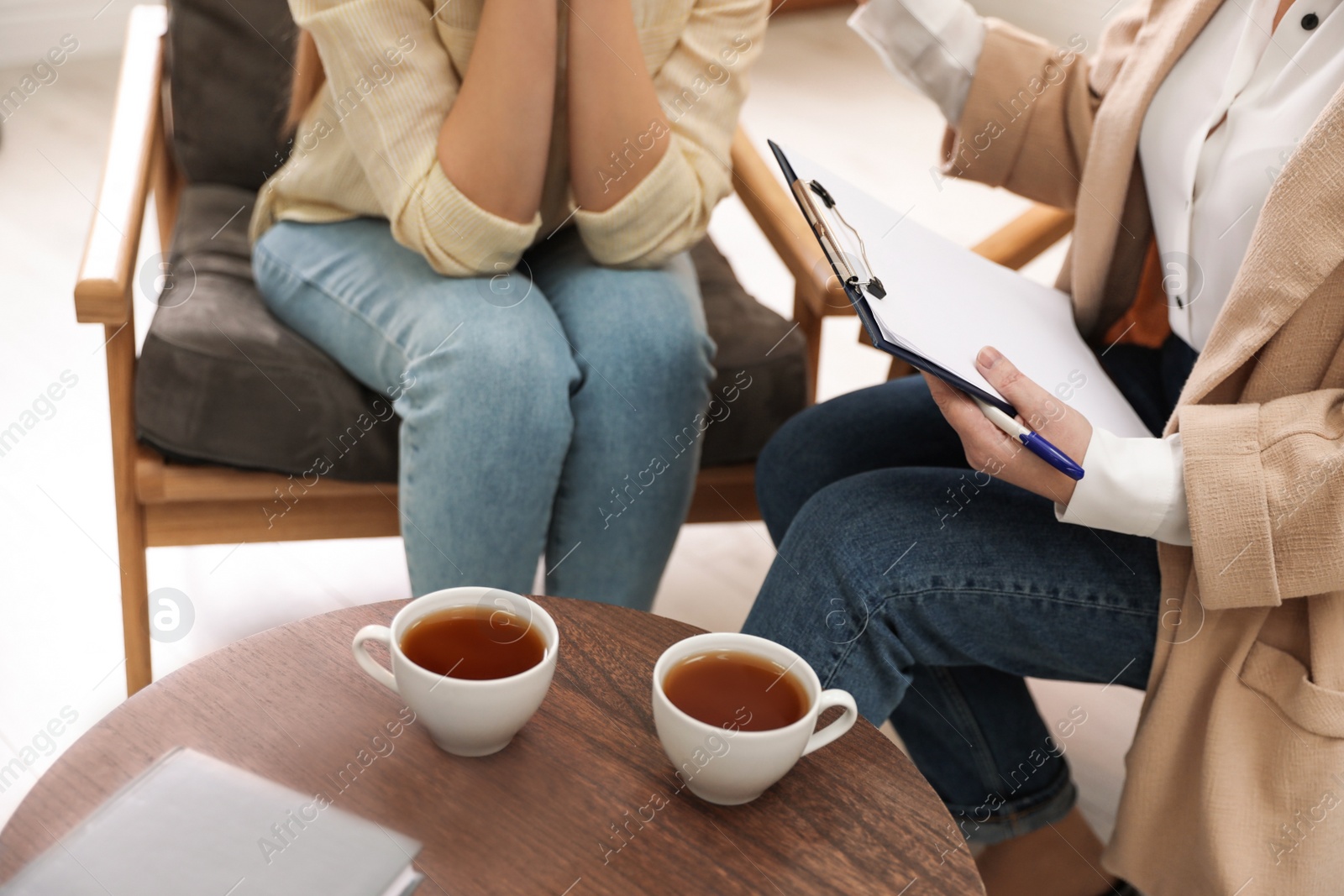 Photo of Professional psychotherapist working with patient in office, closeup