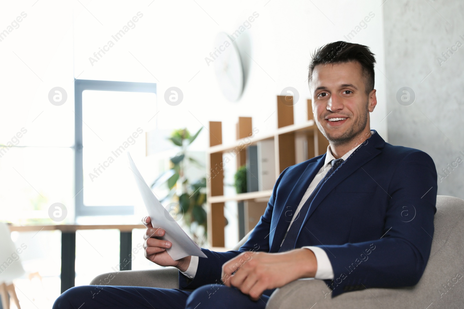 Photo of Male business trainer working with documents in office