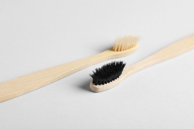Photo of Old bamboo toothbrushes on white background. Eco friendly product
