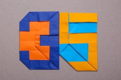 Photo of Number thirty five made of paper on light brown background, top view