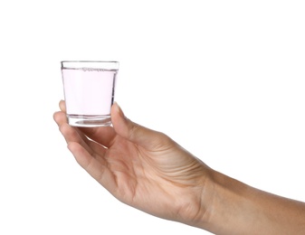 Woman holding glass with mouthwash for teeth care on white background