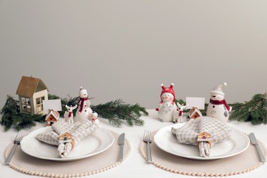 Photo of Beautiful festive place setting with stylish decor for Christmas dinner on white wooden table. Space for text