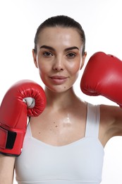 Photo of Beautiful woman in boxing gloves on white background