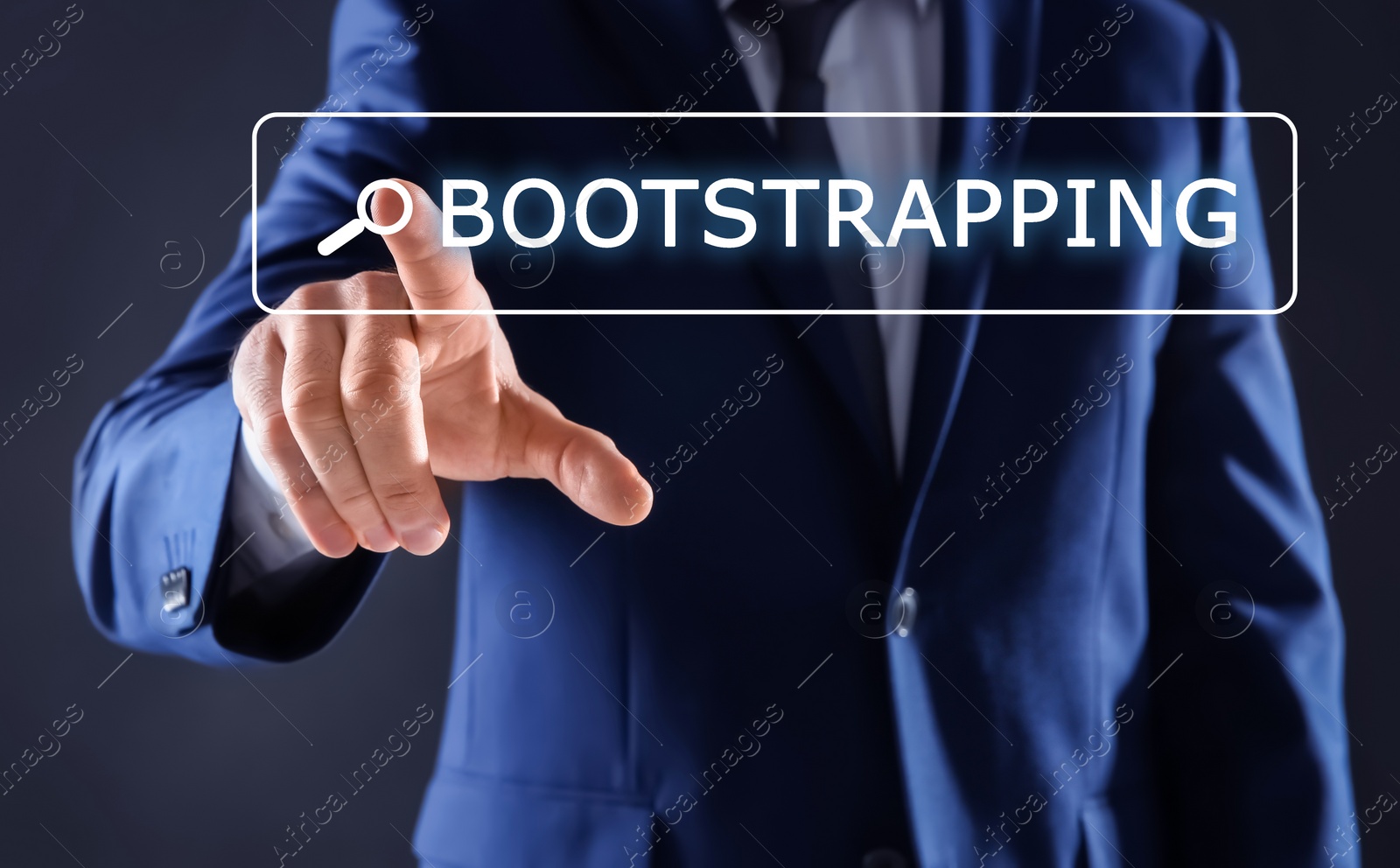 Image of Businessman touching virtual screen with word BOOTSTRAPPING in search bar against dark background, focus on hand
