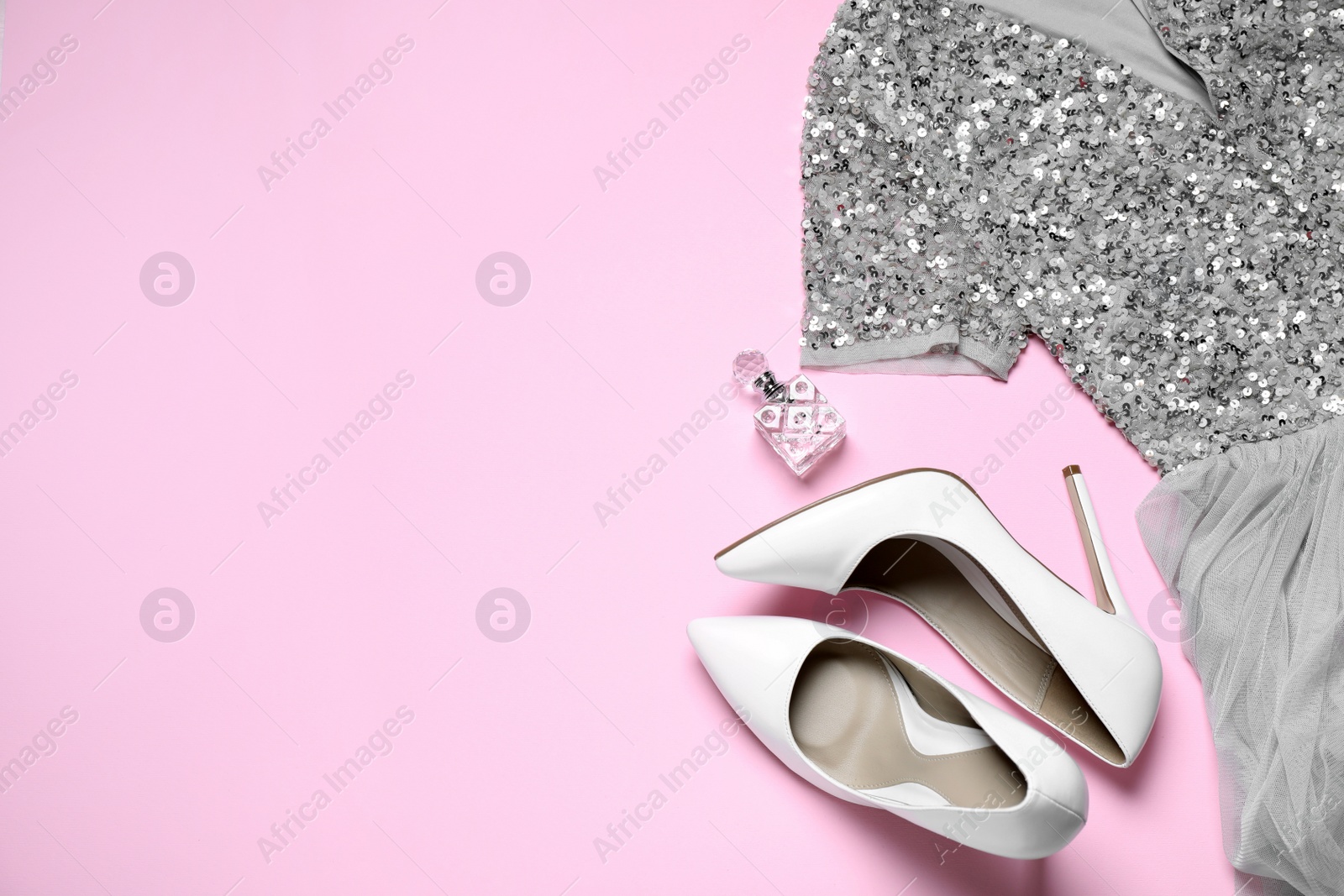 Photo of Flat lay composition with beautiful shoes on pink background, space for text