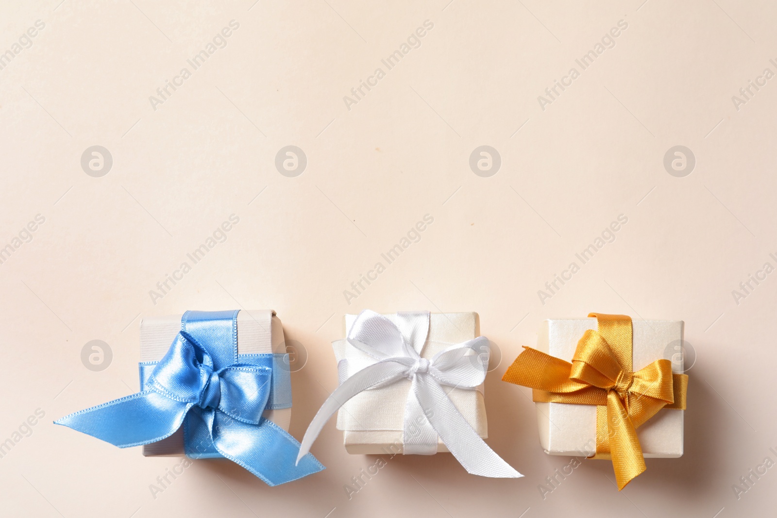 Photo of Beautiful gift boxes on light background, top view