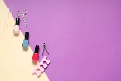 Nail polishes and set of pedicure tools on color background, flat lay. Space for text