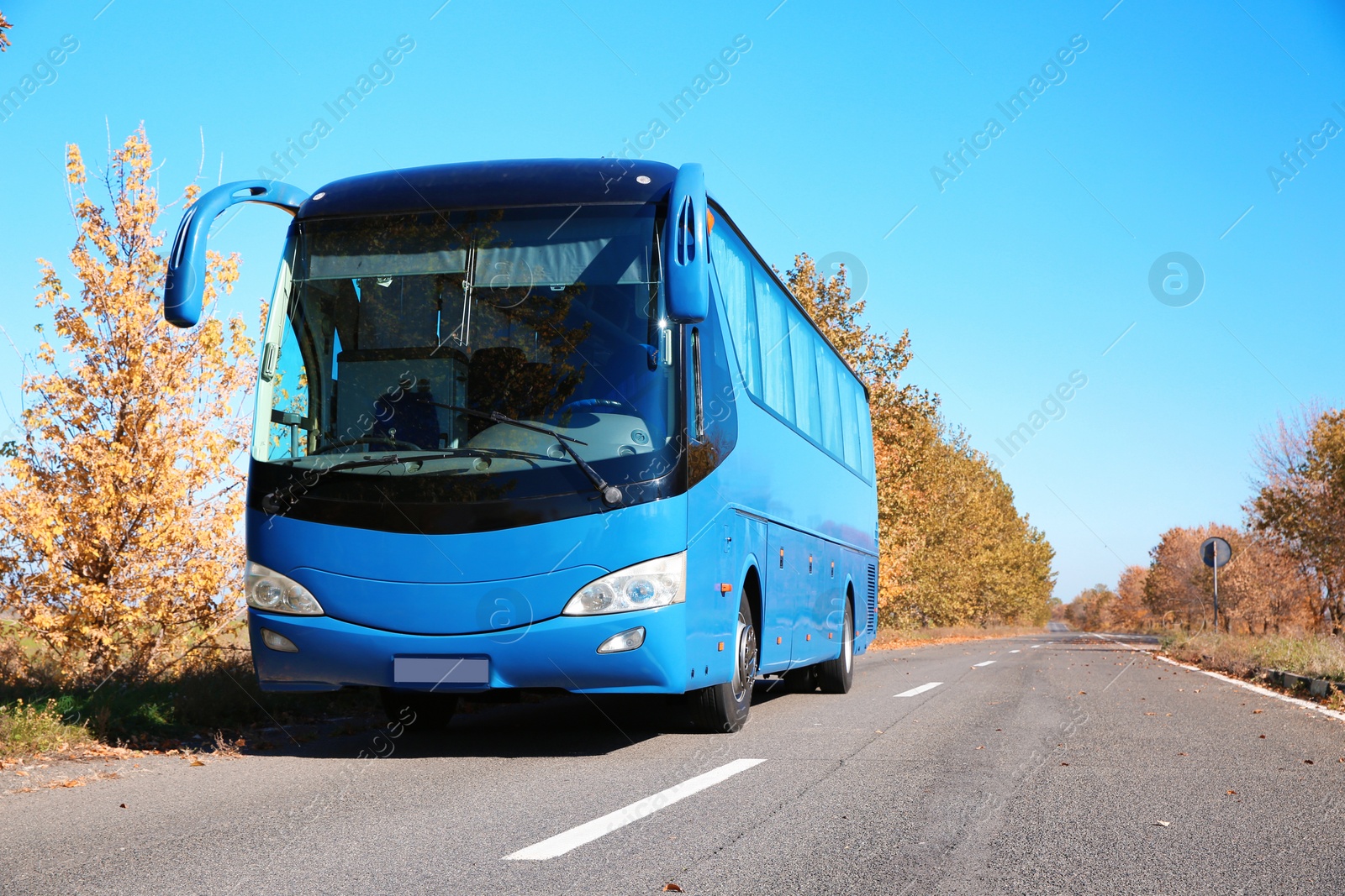 Photo of Modern blue bus on road. Passenger transportation