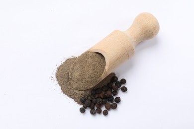 Aromatic spice. Ground and whole black pepper with wooden scoop on white background, top view