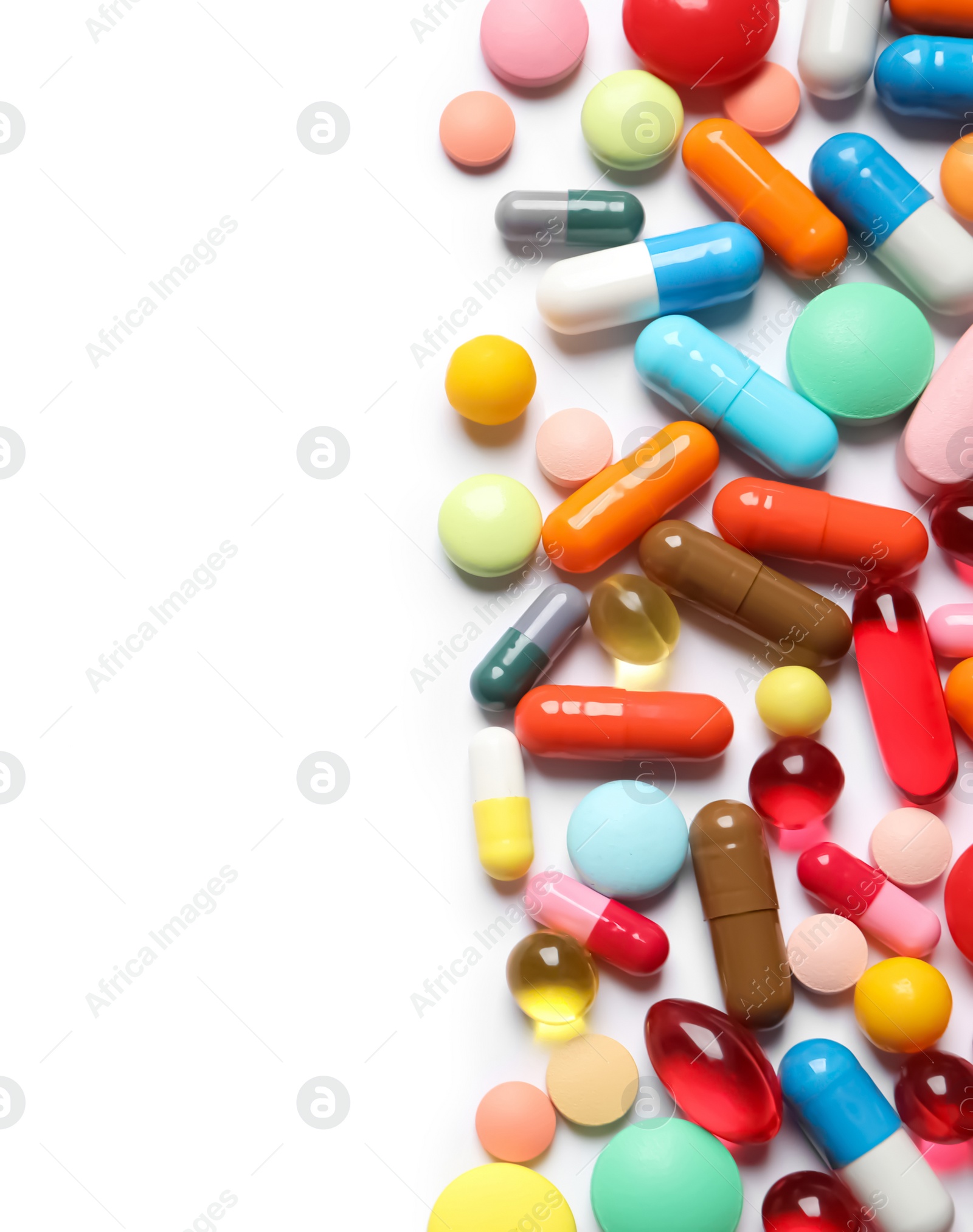 Photo of Lots of different colorful pills isolated on white, top view