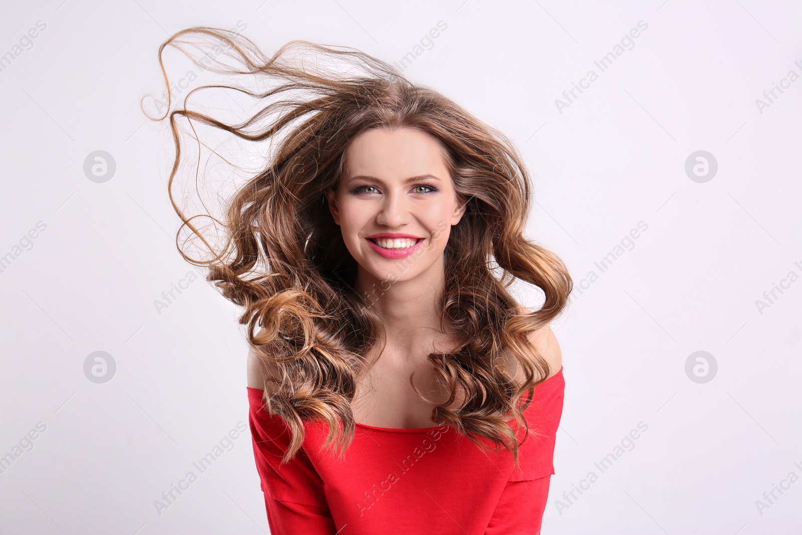 Photo of Portrait of young woman with long beautiful hair on white background