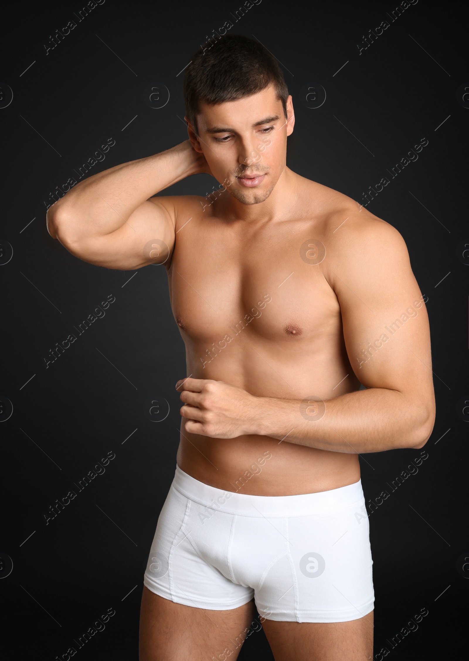 Photo of Man with sexy body on grey background