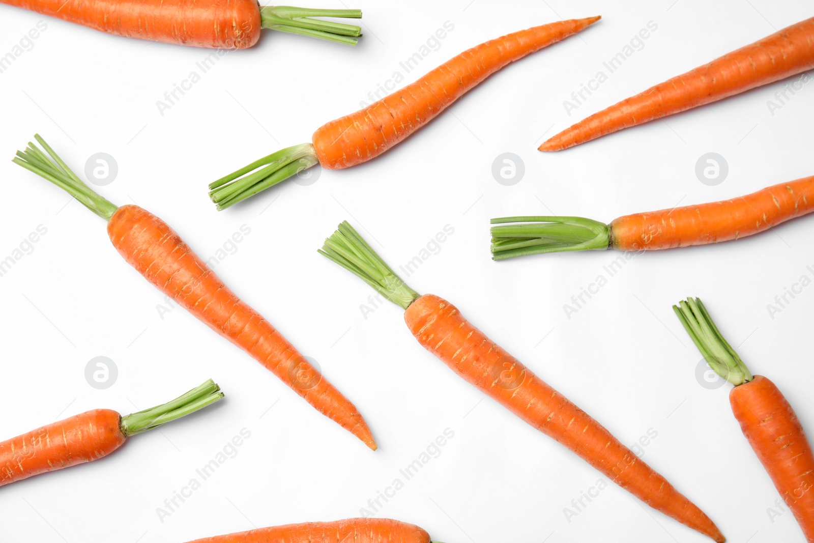 Photo of Ripe fresh carrots on white background