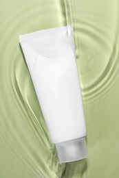 Photo of Tubefacial cleanser in water against olive background, top view