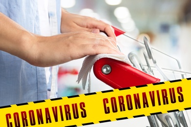 Image of Preventive measure in public places during coronavirus outbreak. Woman holding shopping cart handle with tissue paper at supermarket, closeup 