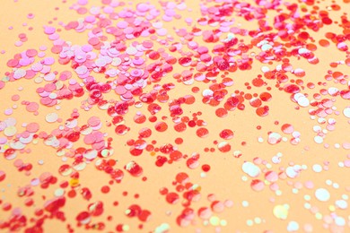 Shiny bright red glitter on beige background