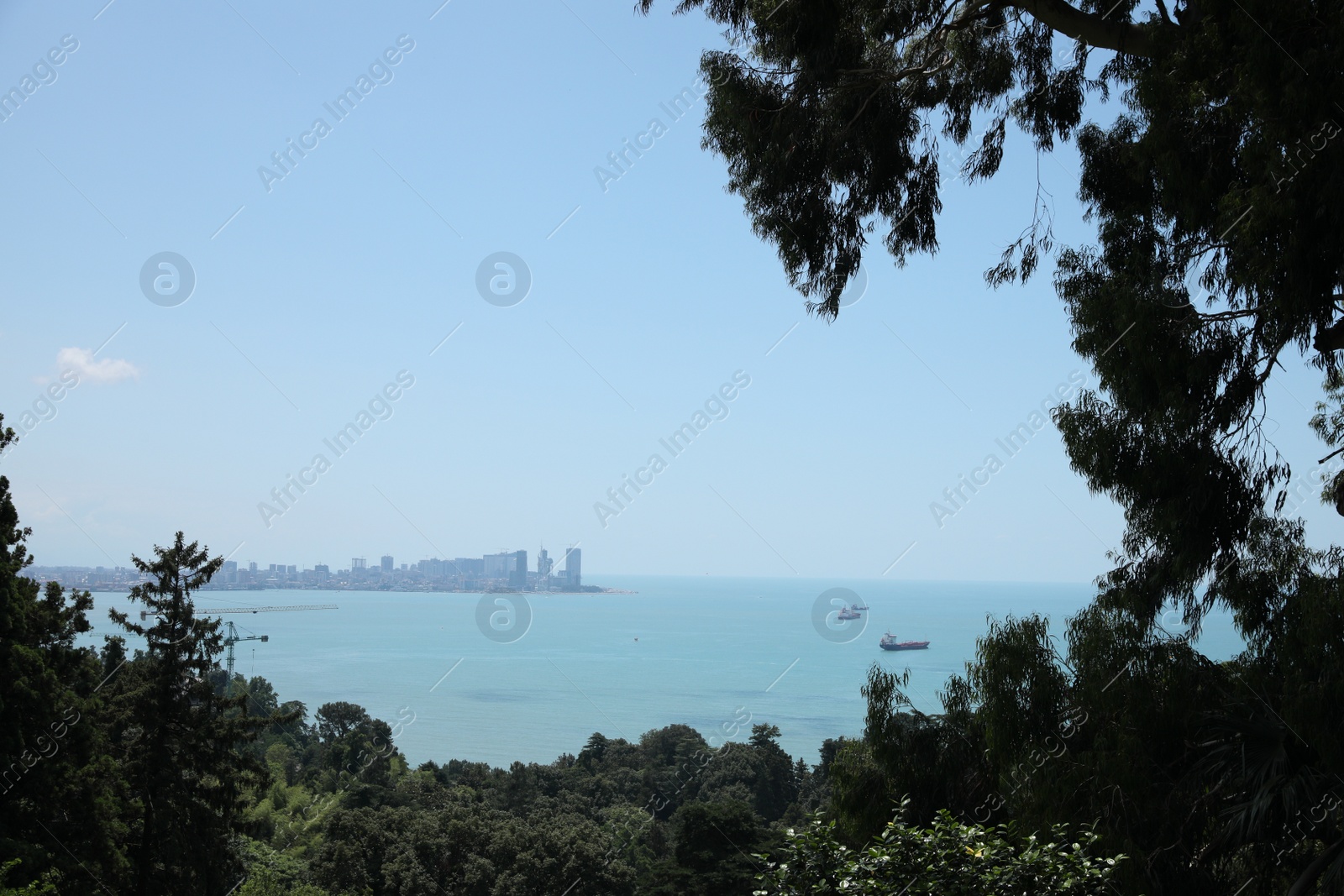 Photo of Picturesque view of beautiful sea and distant city on sunny day