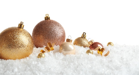 Photo of Christmas tree decoration on artificial snow against white background