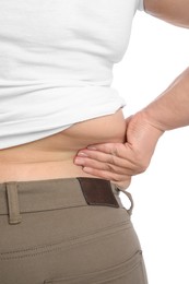 Photo of Overweight woman in tight shirt and trousers on white background, closeup. Back view