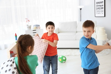 Photo of Cute little children playing together, indoors