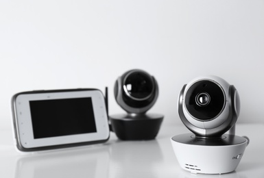 Modern CCTV security cameras and monitor on white background