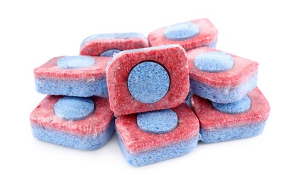 Photo of Pile of dishwasher detergent tablets on white background