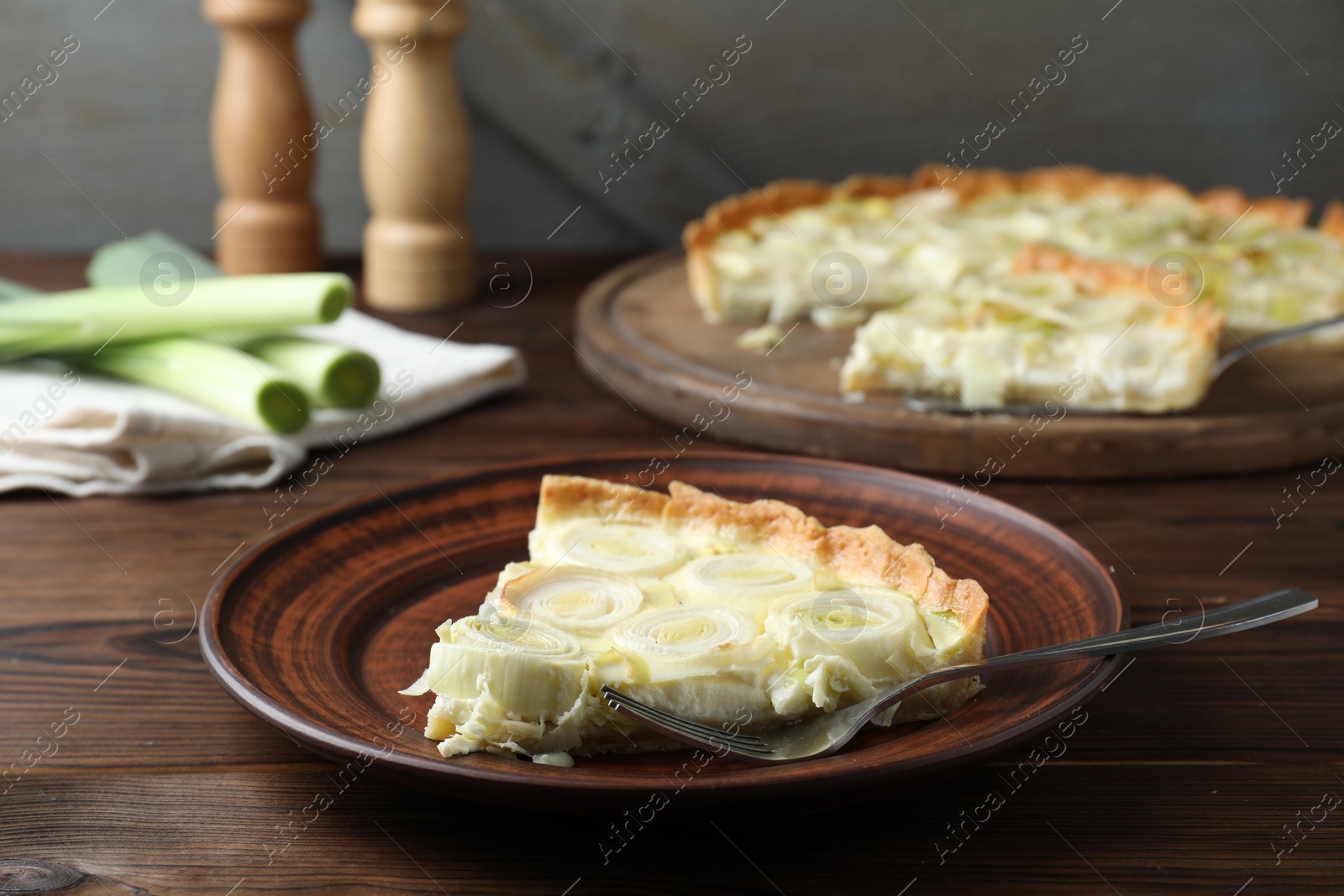 Photo of Tasty leek pie served on wooden table
