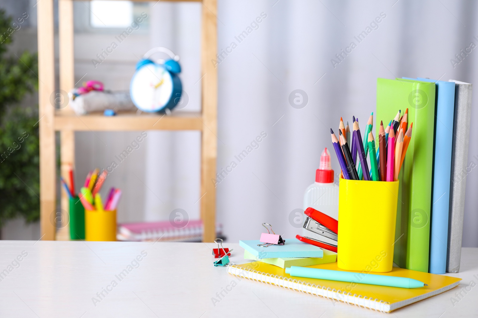 Photo of Different school stationery on white table indoors. Space for text