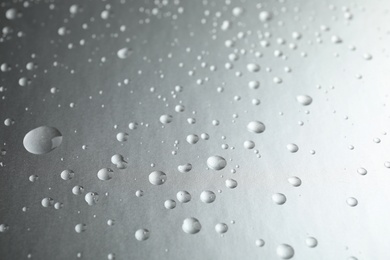 Photo of Many clean water drops on grey background