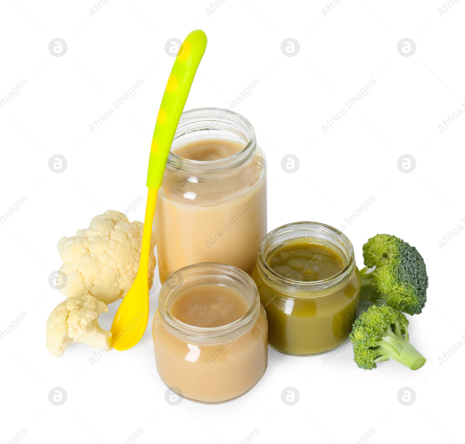 Photo of Tasty baby food in jars, spoon and fresh vegetables isolated on white