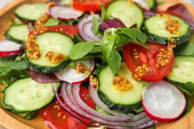 Photo of Tasty salad with different vegetables in wooden plate, closeup